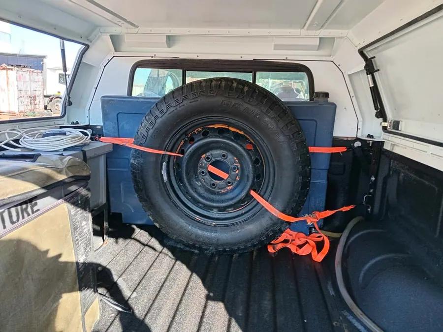 Spare wheel and recovery storage - Practical remote-route equipment and canopy storage details.